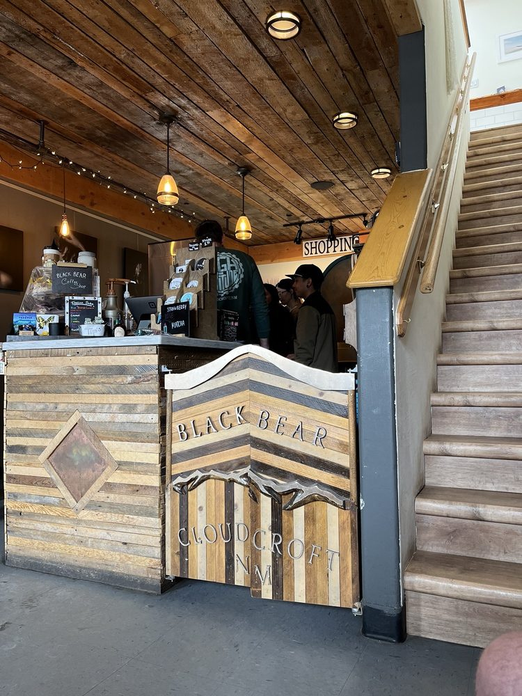 Rustic wood counter and espresso setup inside Black Bear Coffee