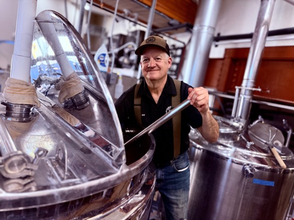 Head brewer at the brew kettle inside Cloudcroft Brewing Company