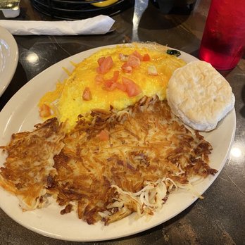 Cheese omelet with hash browns and a biscuit on the side at Dusty Boots Café