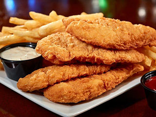 Golden chicken strips with fries, ranch, and ketchup
