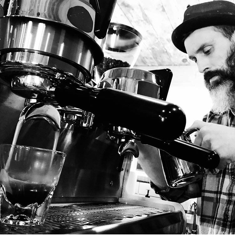 Black Bear Coffee Shop storefront with patio seating on Burro Avenue