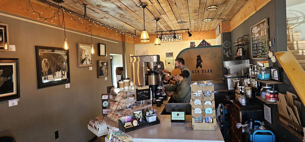 Wide interior view showing counter, framed art, and string lights