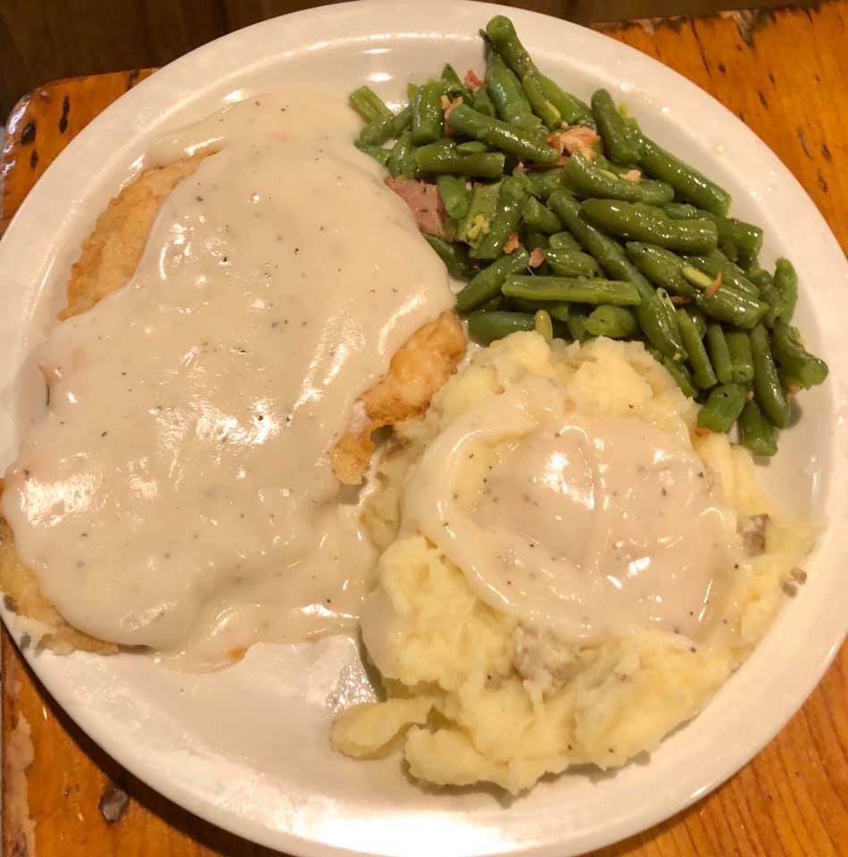 Chicken fried steak with mashed potatoes, gravy, and green beans