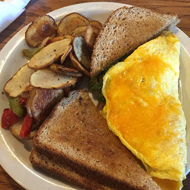 Omelet with toast and home-fried potatoes