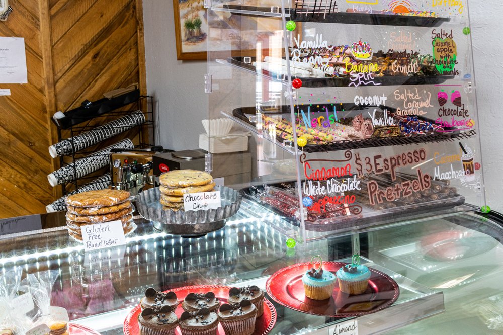 Bakery display case at Eight the Cake with cakes, pastries, and cookies