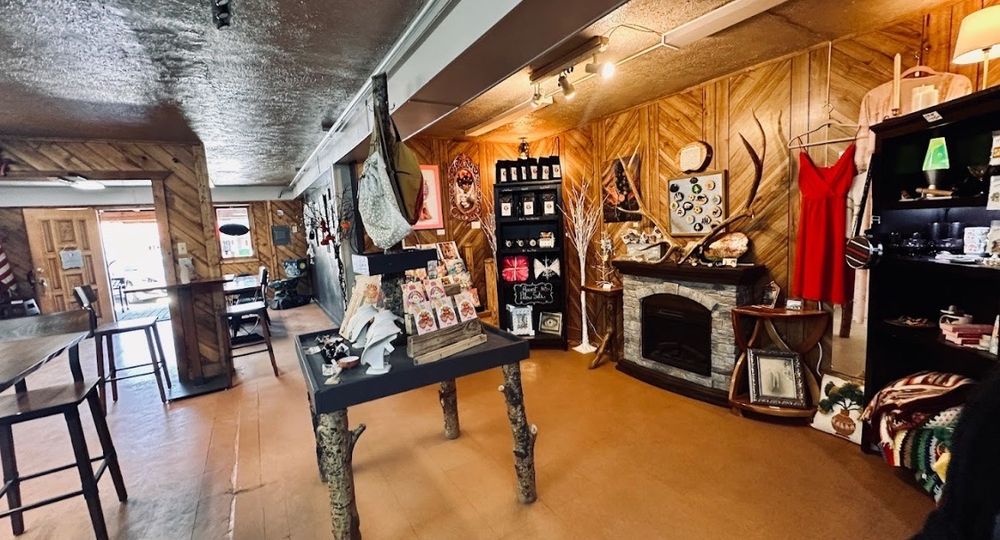 Interior gallery and gift shop space at Eight the Cake with art, gifts, and fireplace