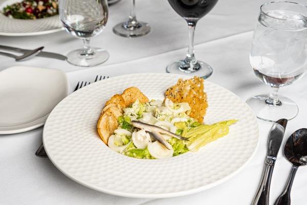 Caesar salad with anchovy, crostini, and parmesan crisp at Eighteen99