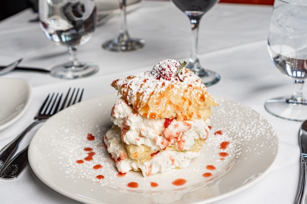 Layered pastry dessert with cream and strawberry at Eighteen99