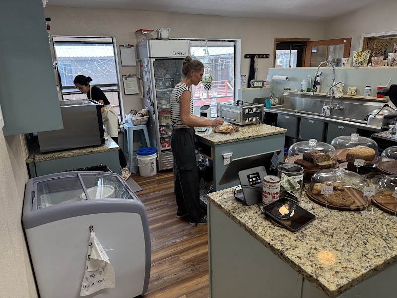 Behind the counter at High Rollin' Coffee with fresh-baked goods on display