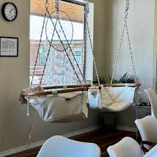 Hammock chairs by the window at High Rollin' Coffee