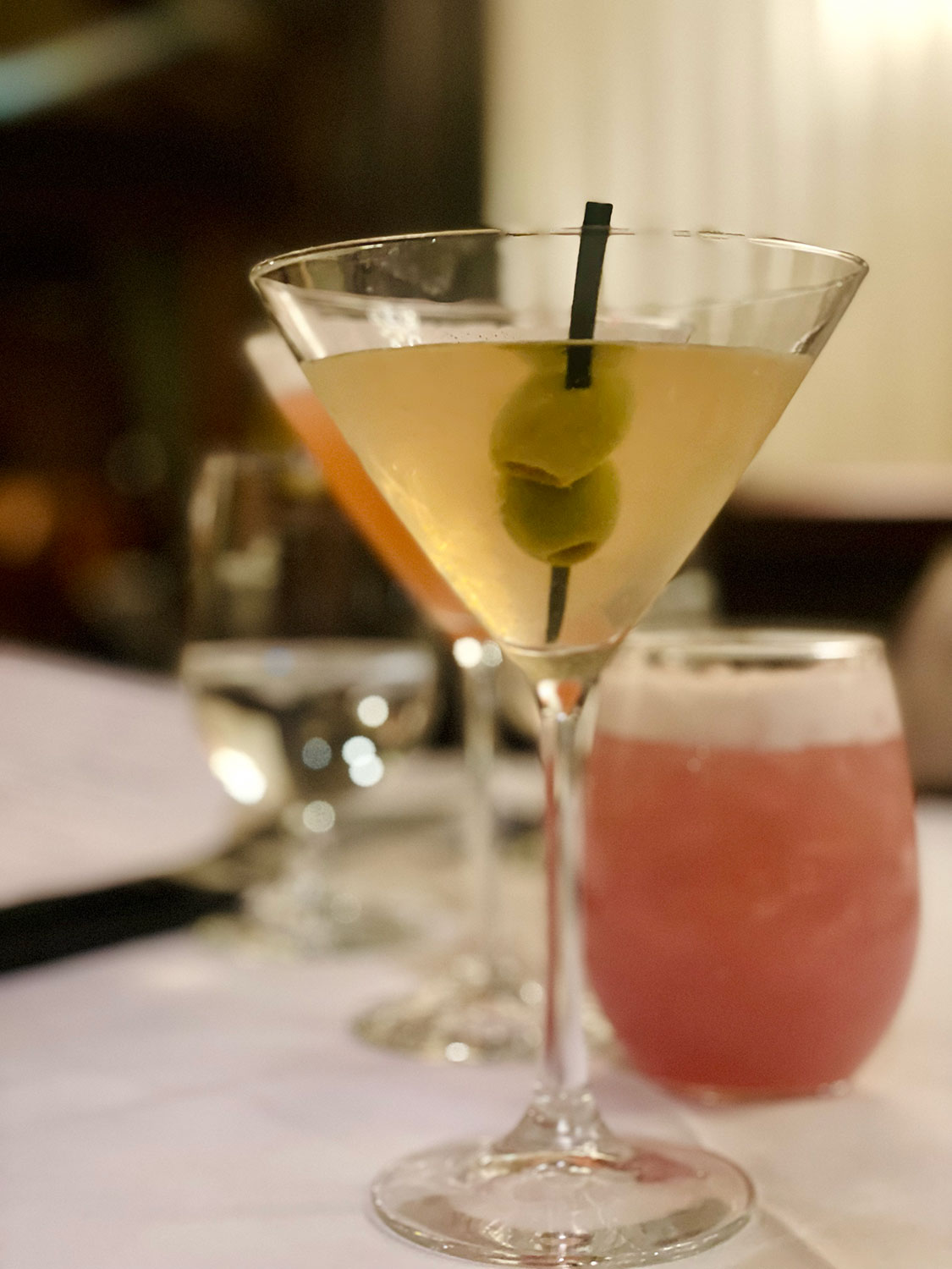 Martini with olives and a pink cocktail at St. Andrew's Bar