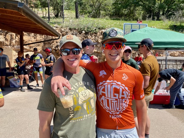 Two riders posing post-race &mdash; one in a High Altitude Cloudcroft tee, the other in a High Altitude Racing orange jersey