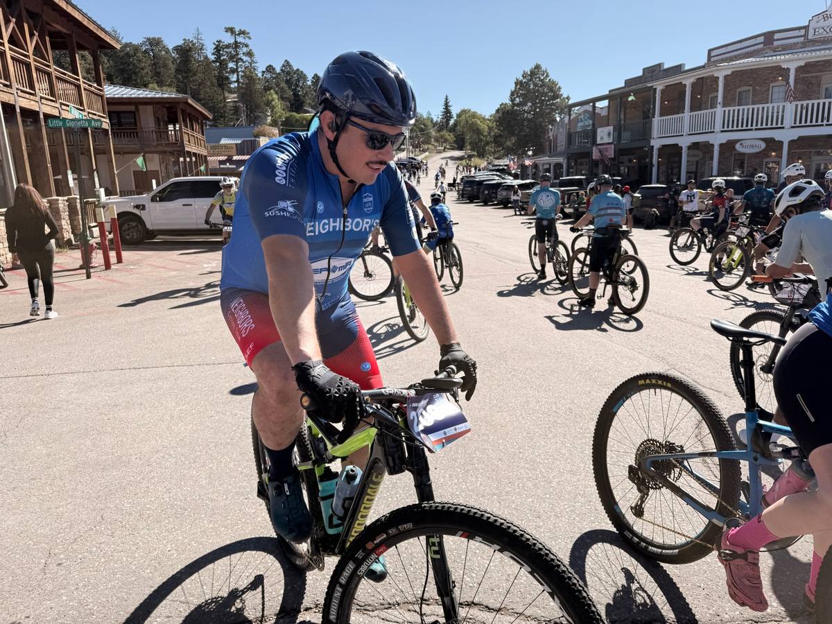 Rider in Neighbor’s Cycling kit at the start, with the Burro Avenue streetscape behind