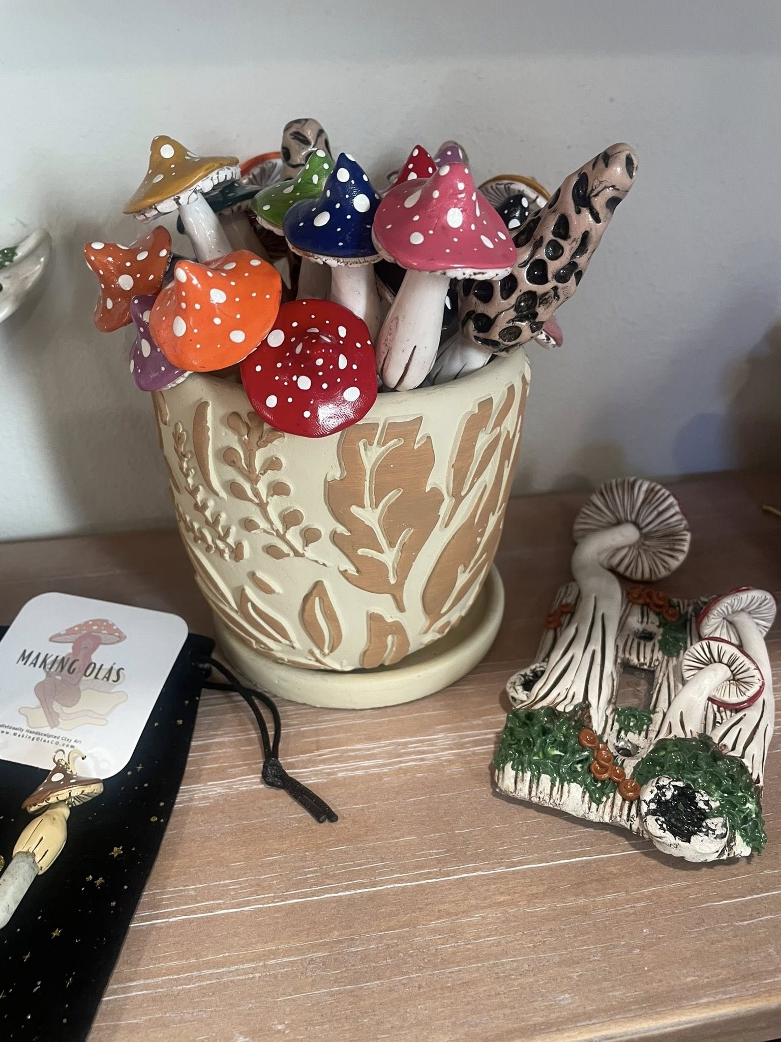 Handmade ceramic mushroom stakes in a botanical-pattern pot