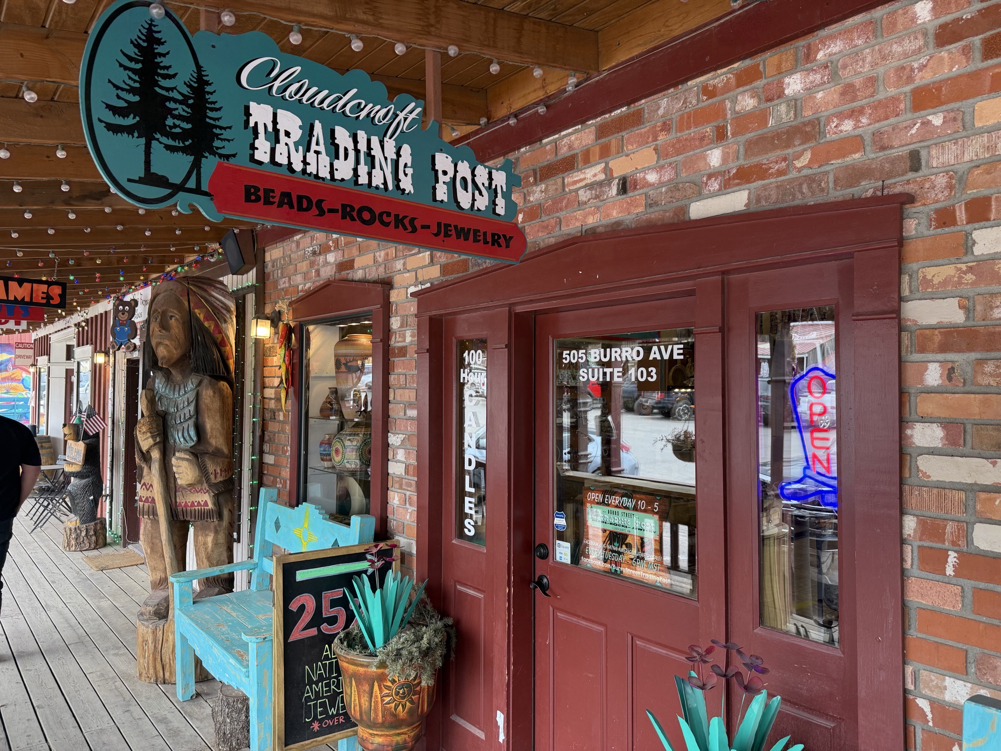 Burro Street Trading Post — entrance with carved figure under the Trading Post sign