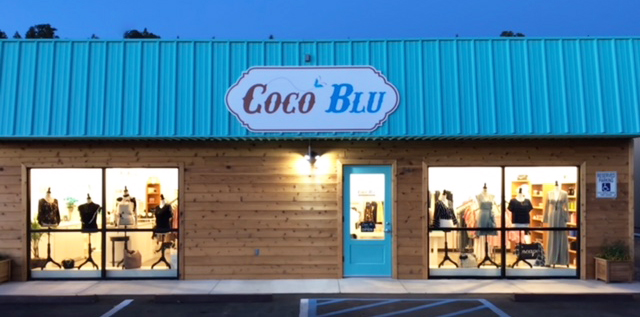 CoCo Blu — boutique storefront with turquoise awning at dusk