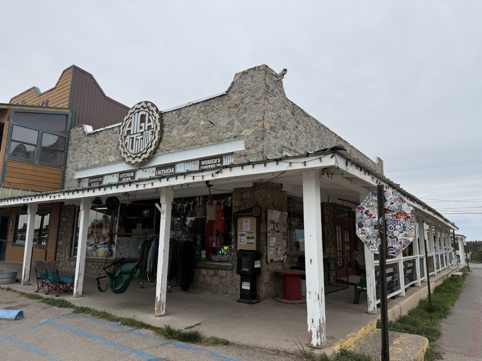 High Altitude — stone-walled corner shop with covered porch