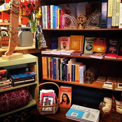 Yoga book section at Instant Karma with Bhakti Yoga, Karma Yoga, Krishna books, and a small basket of cards