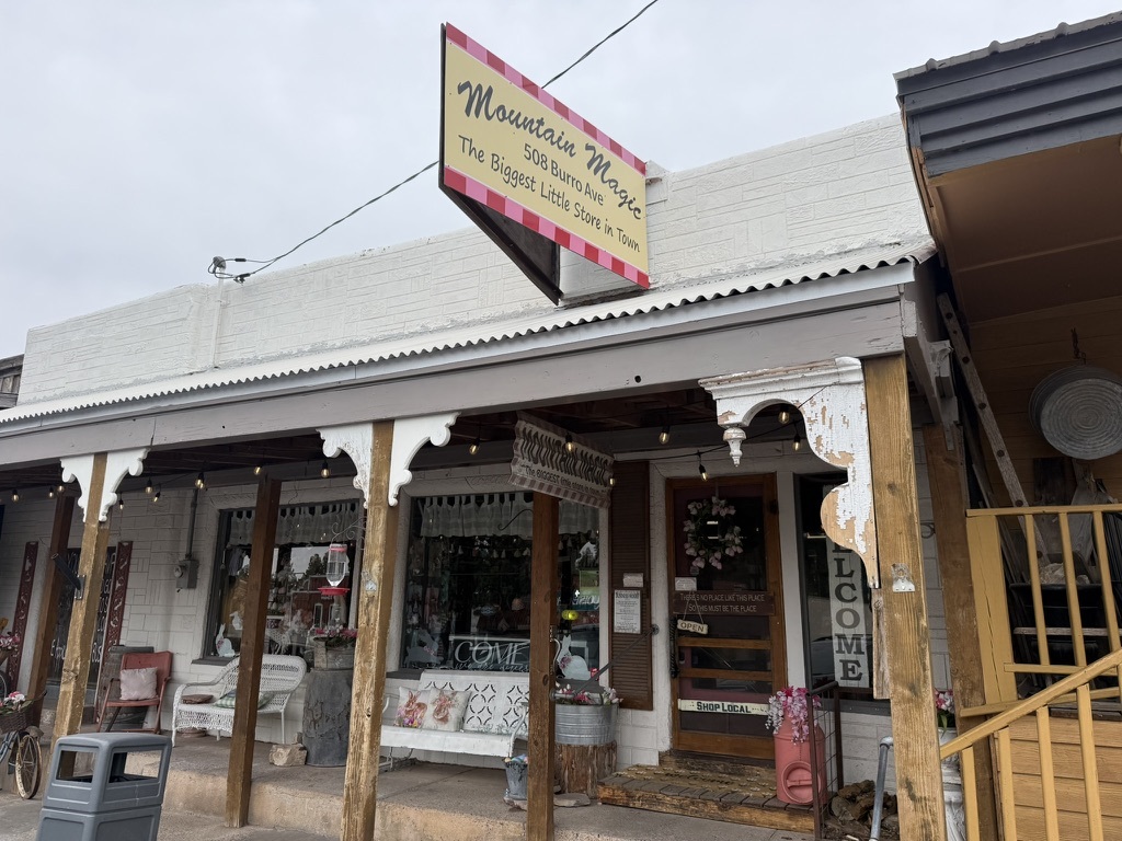 Mountain Magic storefront on Burro Avenue with the diamond Biggest Little Store in Town sign above the boardwalk entry