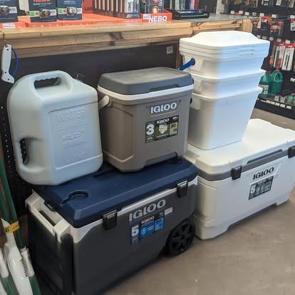 Stack of Igloo coolers and a water cube container on display in the camping section at New Village Hardware