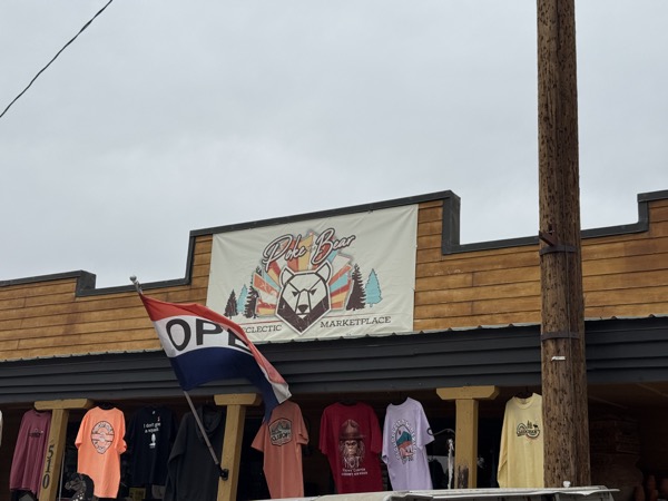 Poke The Bear — boardwalk storefront with bear banner and t-shirt racks