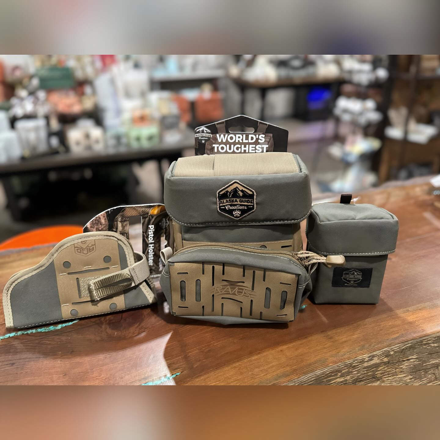 Outdoor gear bags and tactical pouches displayed on a table at The Highland