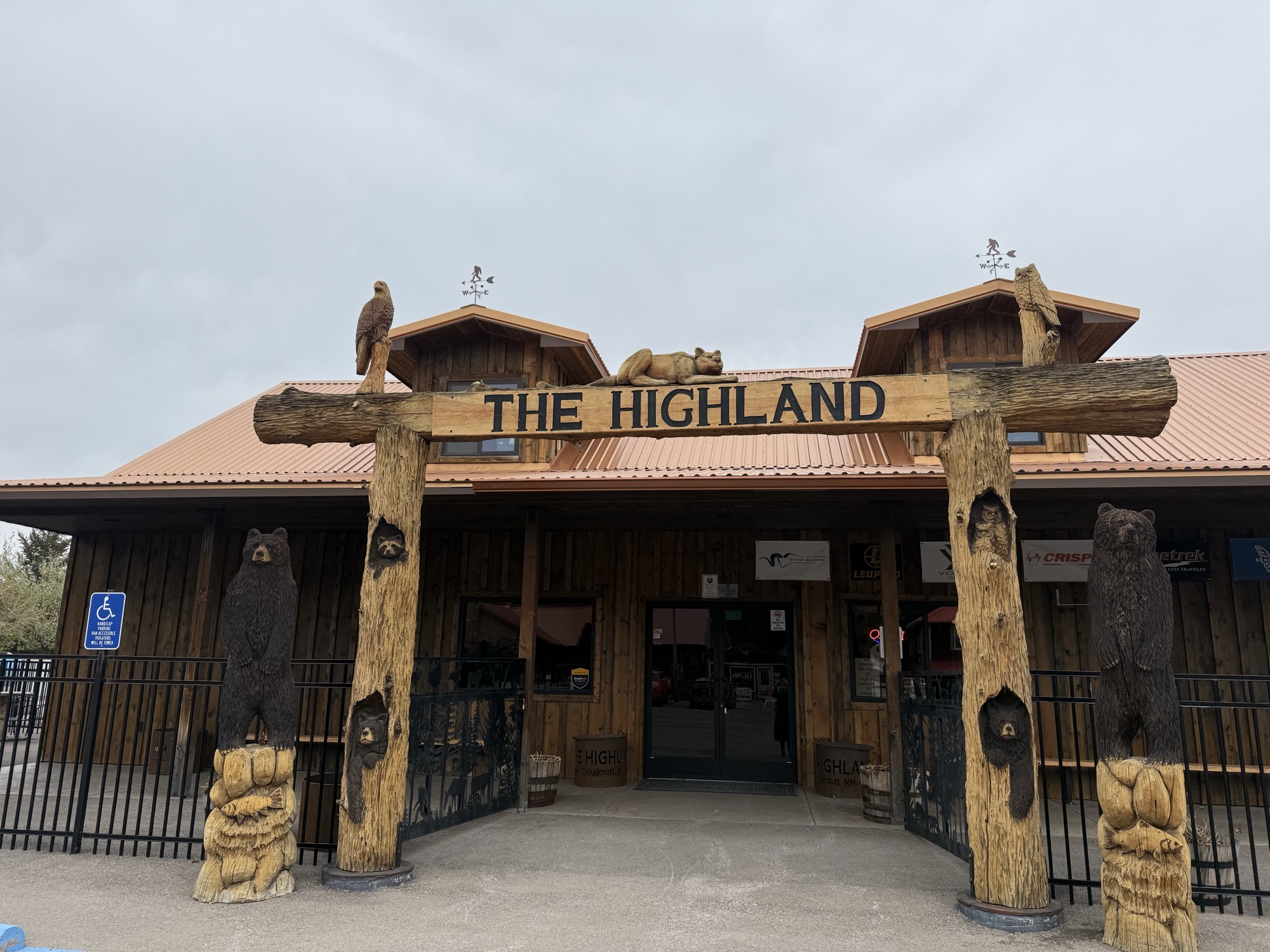 The Highland — carved bear-and-eagle entrance gateway