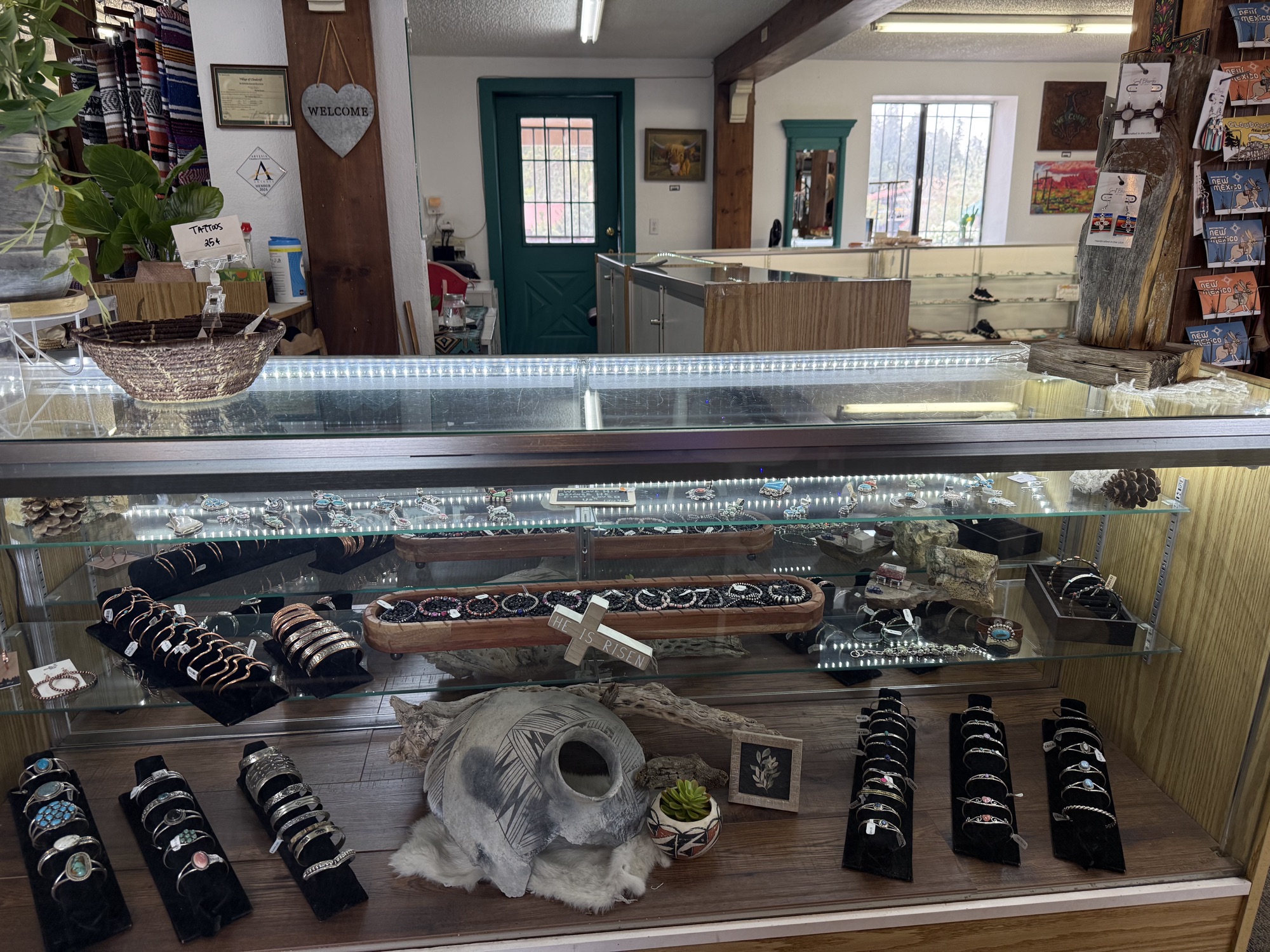 Long lit display case full of sterling silver and turquoise bracelets, rings, and pendants