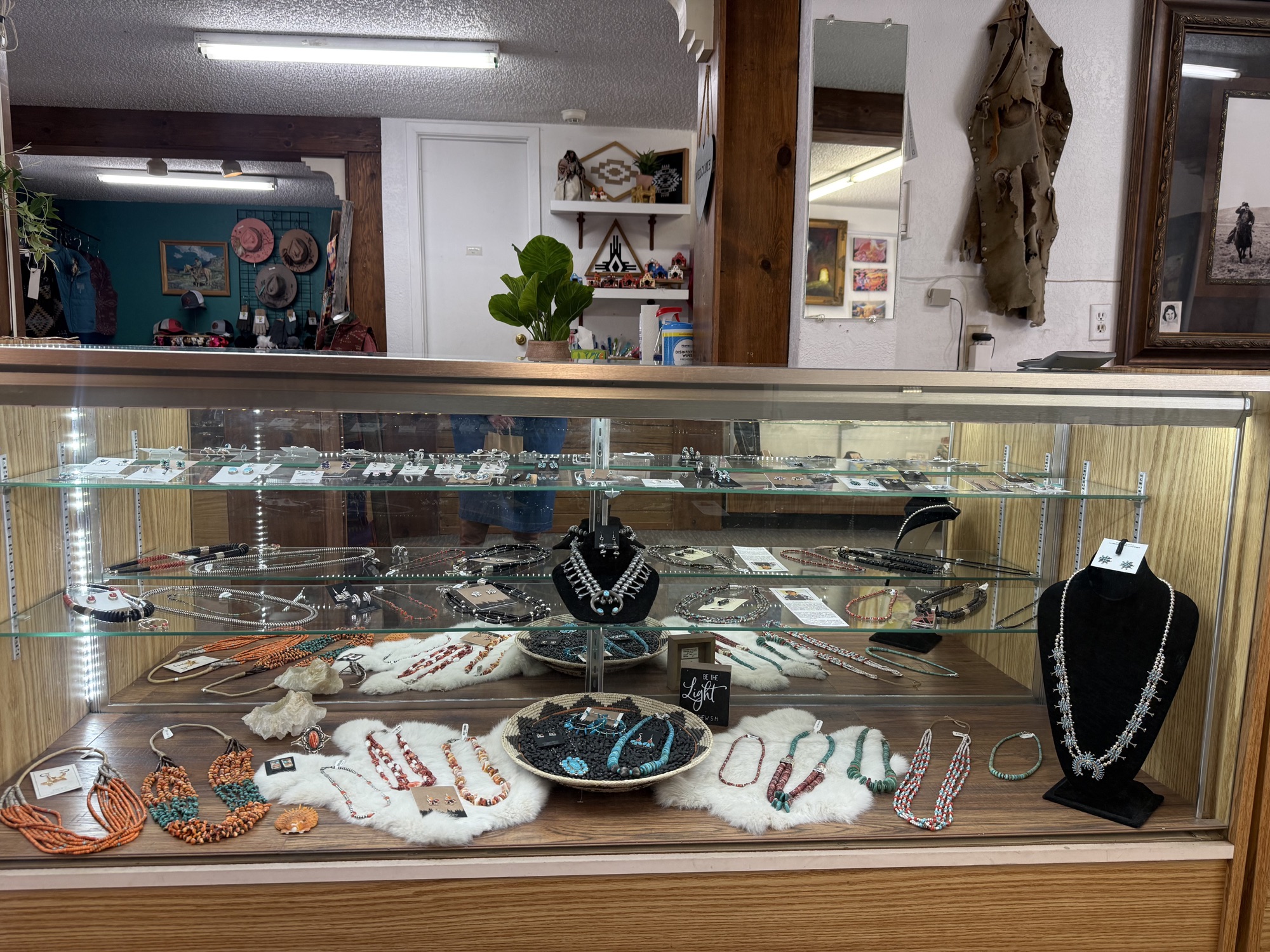 Display case with turquoise multi-strand necklaces and beaded jewelry at The Turquoise Shop