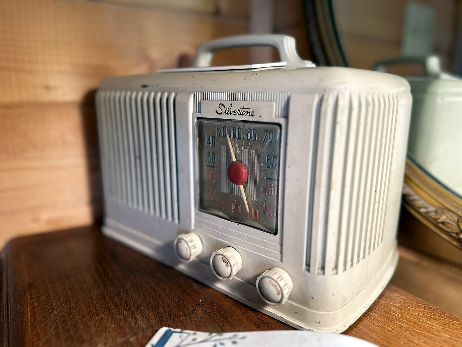 Vintage Silvertone tube radio on a wooden dresser at the Burro Street Boardinghouse