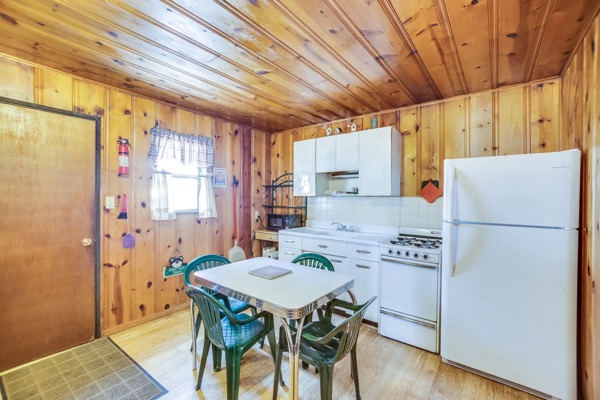 A vintage knotty-pine cabin at The Cabins at Cloudcroft, nestled among tall pines