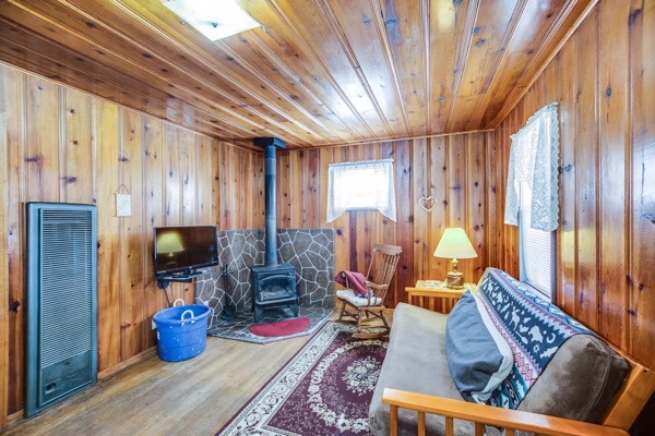 Cabin interior with knotty-pine walls at The Cabins at Cloudcroft
