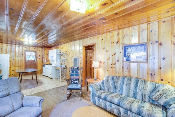 A cabin porch and Adirondack seating at The Cabins at Cloudcroft