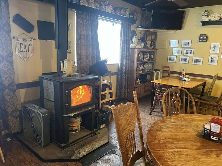 Dusty Boots Cafe interior with wood-burning stove and wood-floor dining room