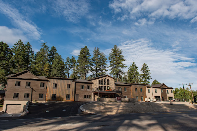Grand Cloudcroft Hotel full exterior view on a clear day surrounded by ponderosa pines