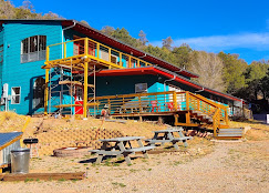 Cloudcroft Hostel exterior with picnic tables and fire pit