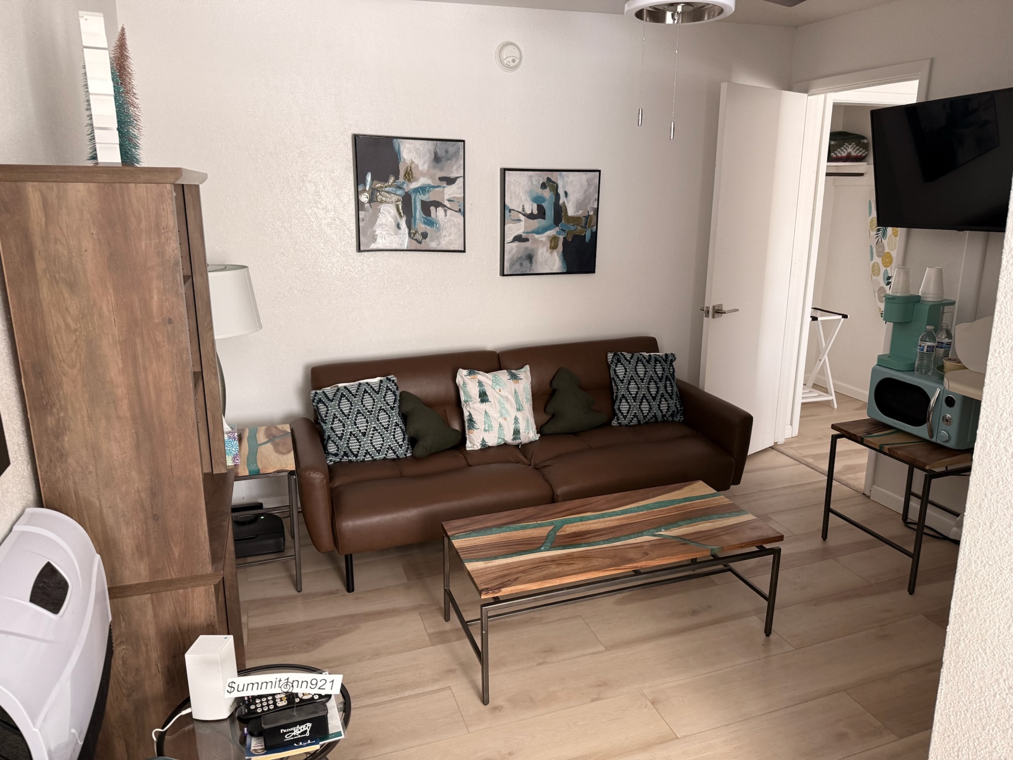 Suite living area with leather sofa and modern art at The Summit Inn